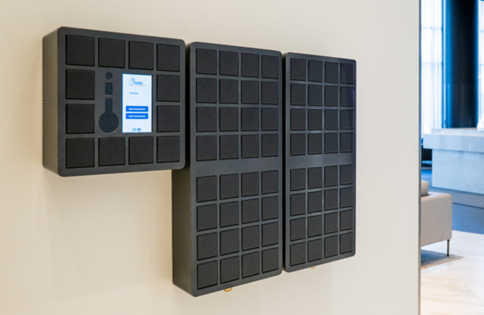 Noki smart key management system with three interconnected wall-mounted cabinets featuring multiple secure compartments and a central touchscreen.