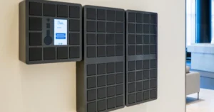 Noki smart key management system with three interconnected wall-mounted cabinets featuring multiple secure compartments and a central touchscreen.