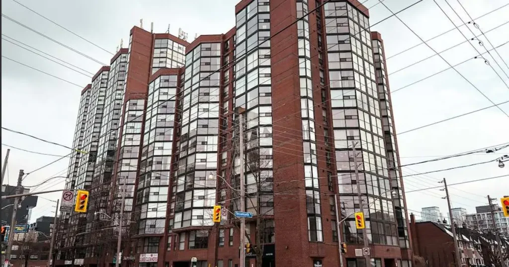 Exterior view of a high-rise condo building on a city street corner, location of a Noki smart locker installation.
